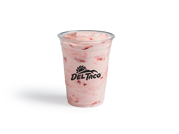 Strawberry milkshake in a clear Del Taco cup with whipped topping and strawberry swirls on a white background.